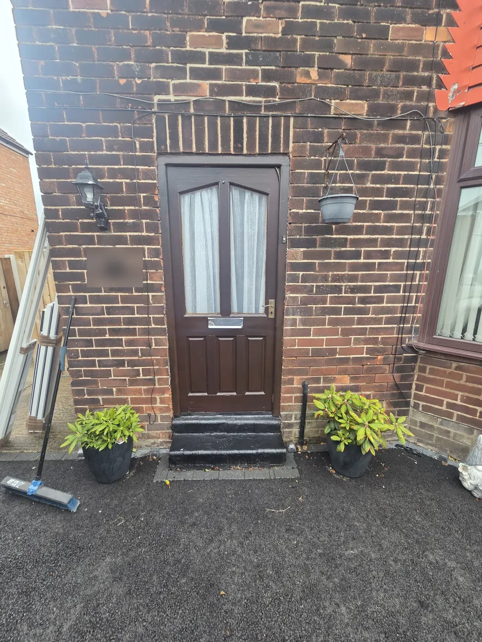 Before: old dark timber front door on a brick house in Hale Barns